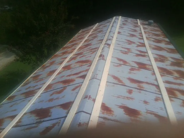 Rusted metal roof panels with new wood purlins before replacement — Storm Damage Roof Repair in Hawthorne by Roofing Brothers